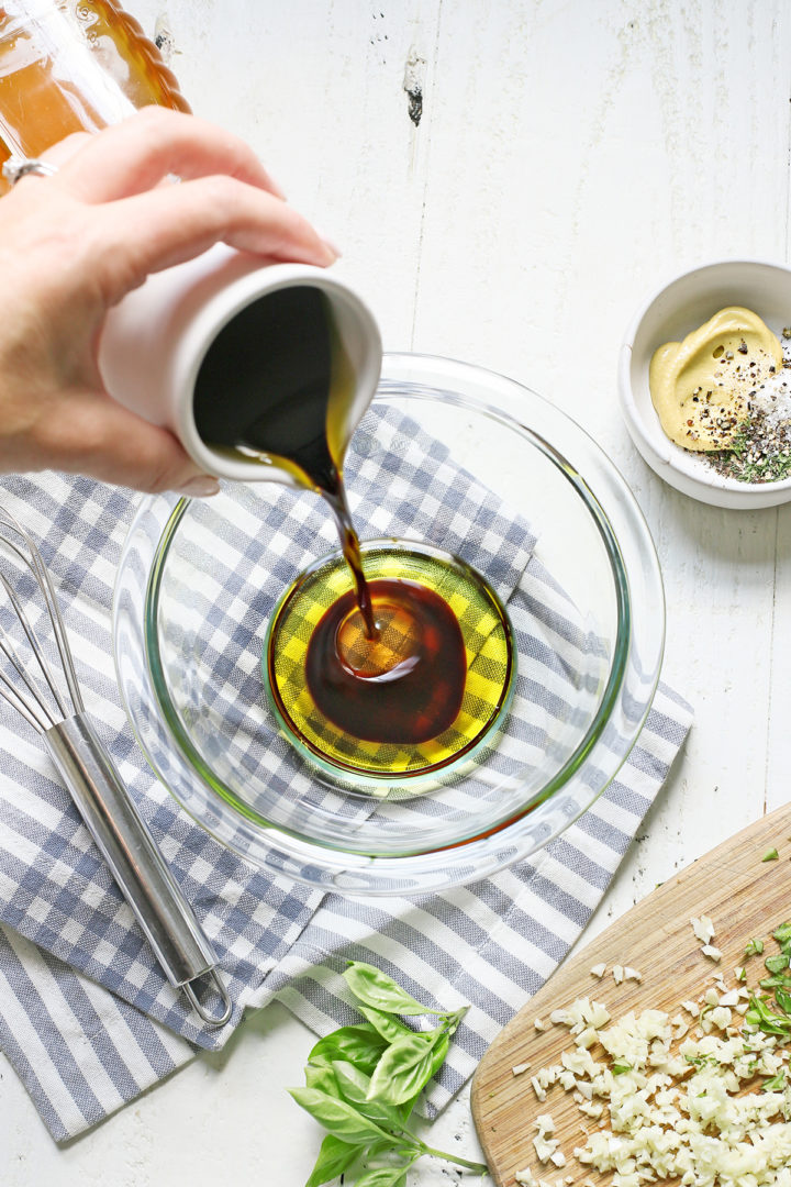 woman showing how to make balsamic chicken marinade