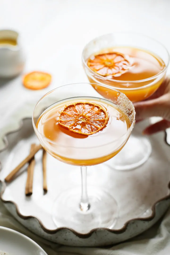 photo of two cocktails garnished with dried orange slices