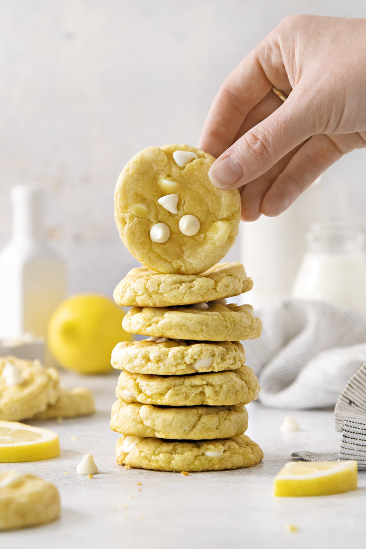 woman picking up a gluten free lemon cream cheese cooki