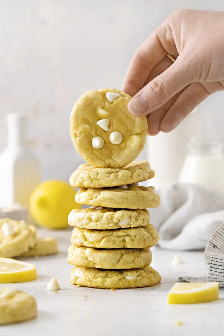woman picking up a gluten free lemon cream cheese cooki