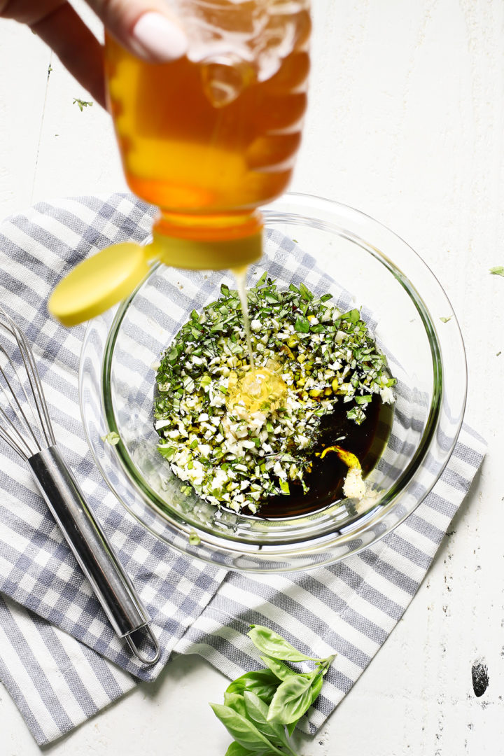 woman adding honey to balsamic chicken marinade