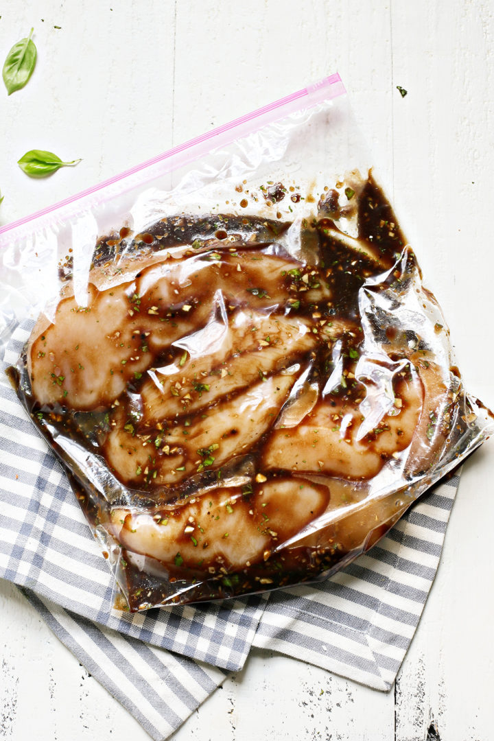 chicken breasts in a plastic bag with bruschetta chicken marinade