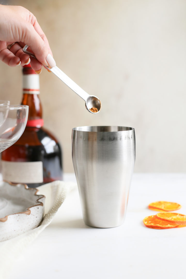 adding pumpkin pie spice to a pumpkin martini recipe