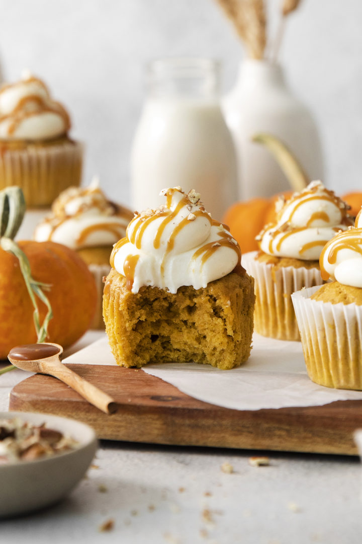 a pumpkin spice cupcake with a bite out of it