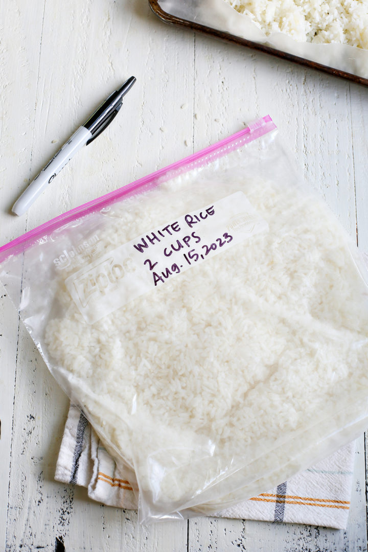 A bag of white rice in a freezer bag, labeled and ready to be frozen. 
