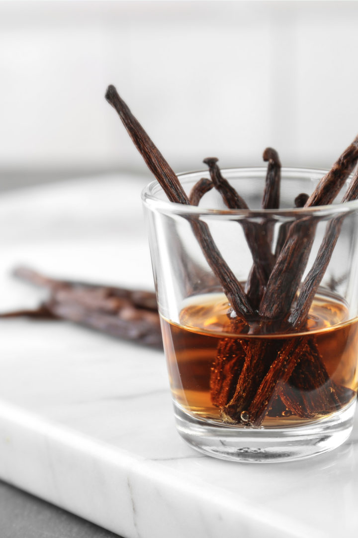 vanilla simple syrup in a glass with vanilla beasn