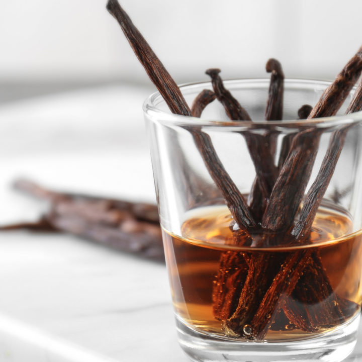 vanilla simple syrup in a glass with vanilla beasn