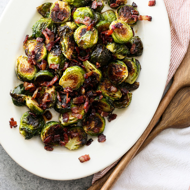 white platter with roasted brussels sprouts on it