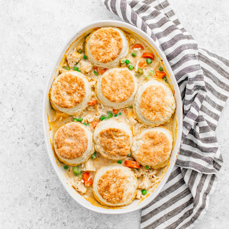 white casserole dish of chicken pot pie topped with biscuit crust