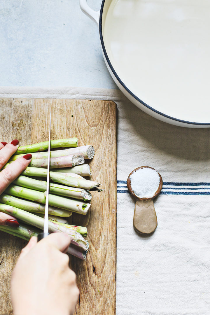 woman cutting asparagus before blanching