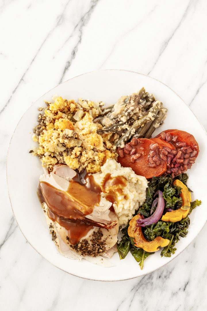 overhead photo of a plate of thanksgiving food including slices of turkey prepared using a turkey brine recipe for smoking