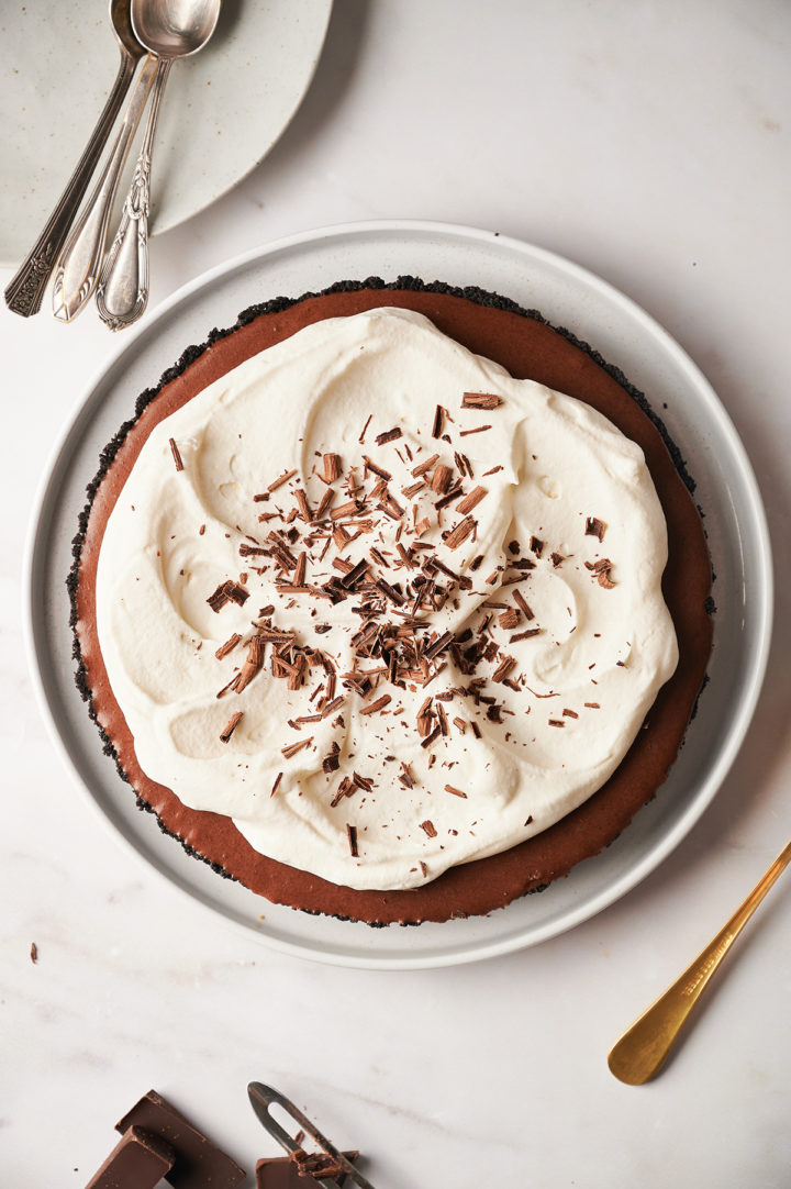 overhead photo of a chocolate tart garnished with shaved chocolate