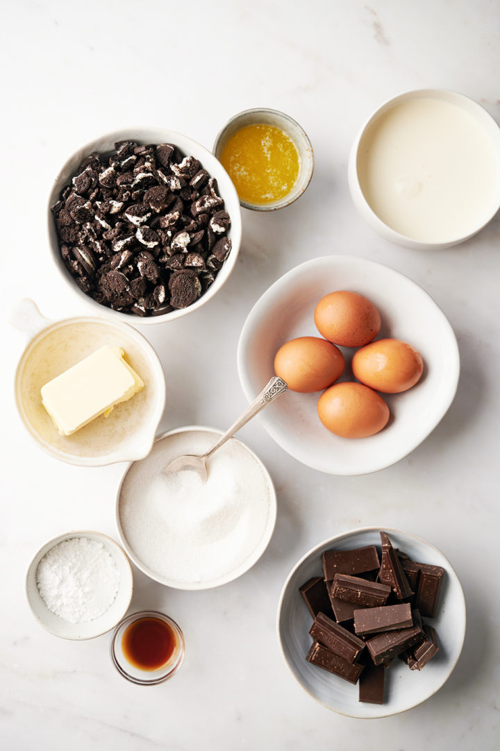 chocolate tart ingredients in bowls on a marble counter