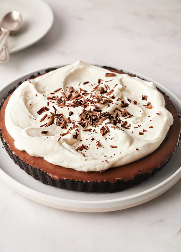 photo of a chocolate tart with whipped cream topping