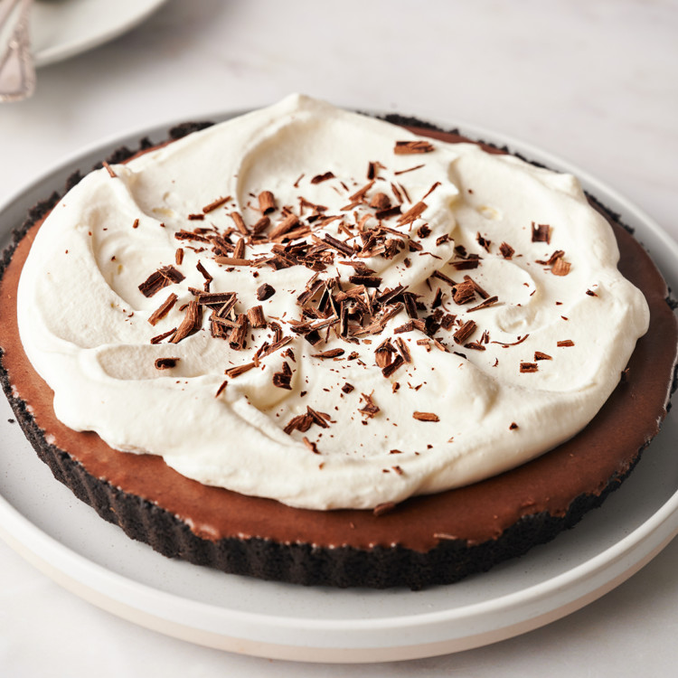 photo of a chocolate tart with whipped cream topping