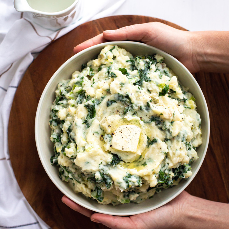 woman holding a bowl of colcannon