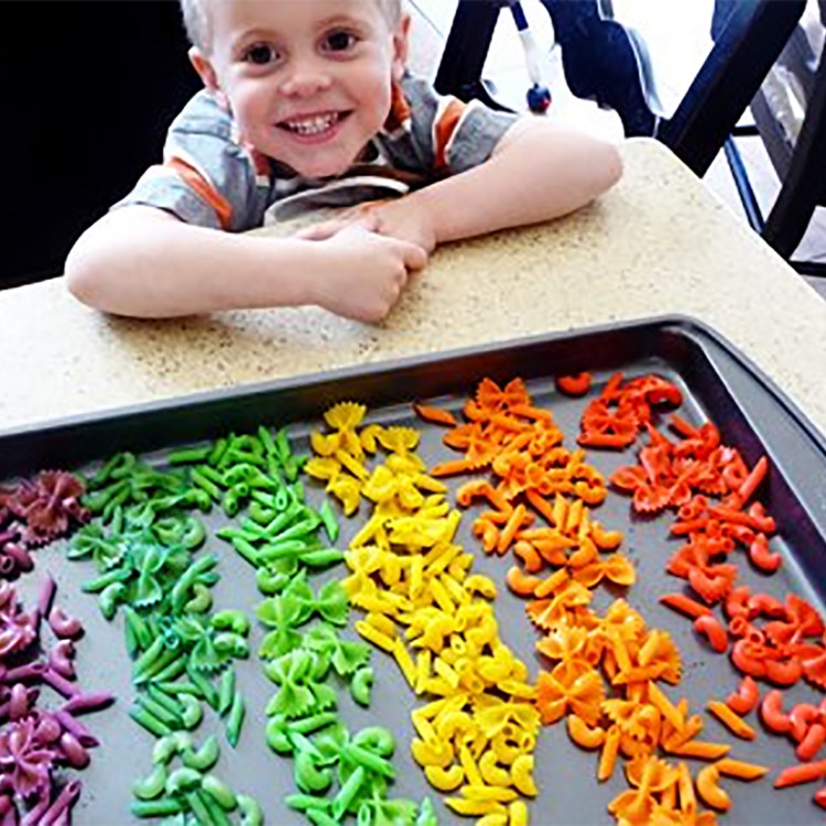 rainbow dyed pasta on a baking sheet