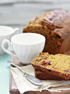 cranberry pumpkin bread on a cutting board