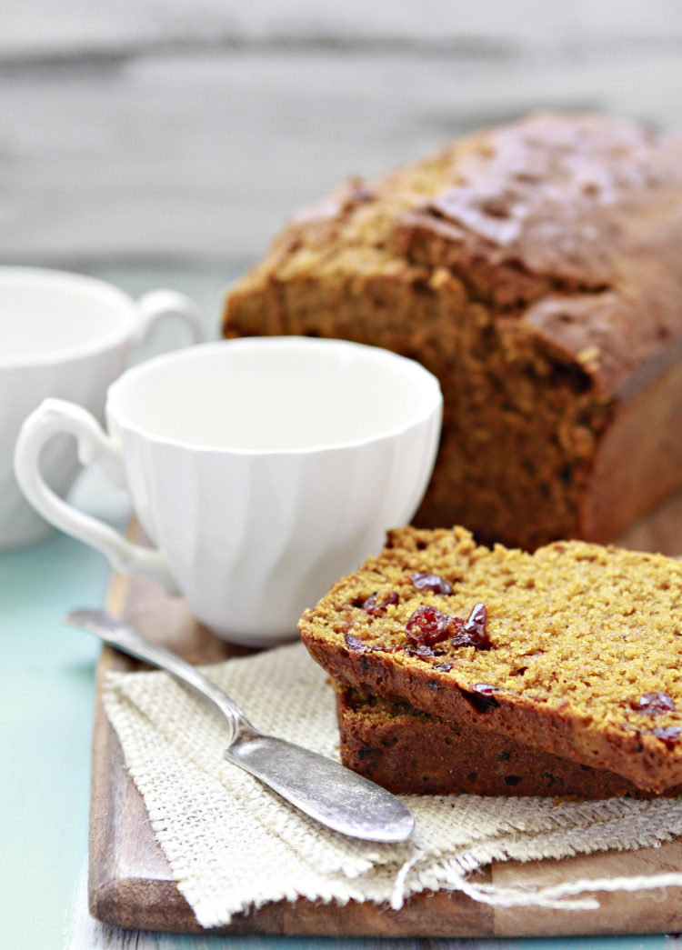 cranberry pumpkin bread on a cutting board