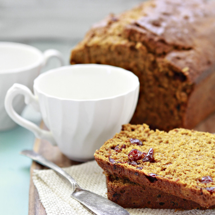 cranberry pumpkin bread on a cutting board