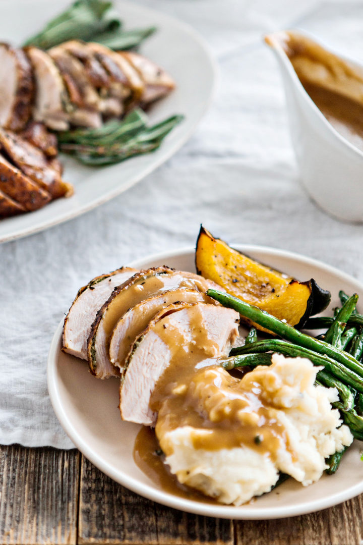 a place with sliced turkey, mashed potatoes, green beans, and squash