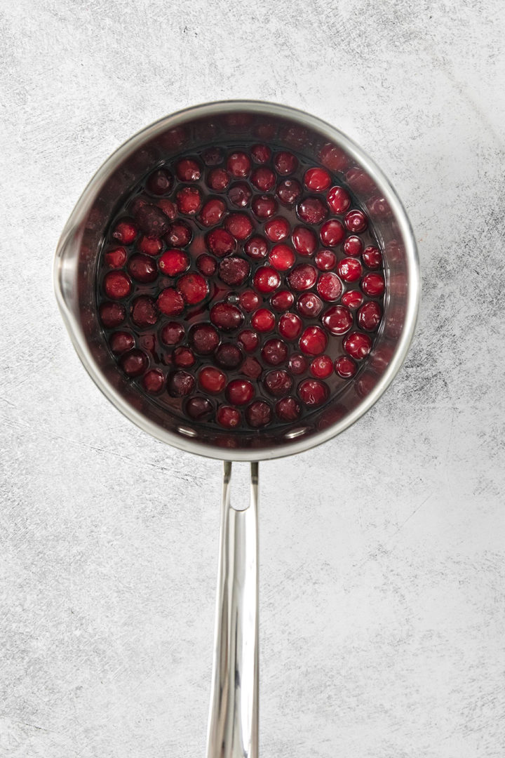 step 1 - how to make cranberry simple syrup: cranberries cooking in sugar water