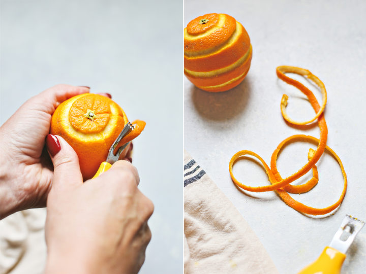 woman demonstrating how to make an orange twist