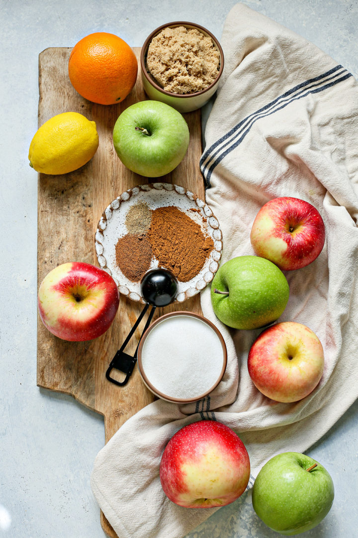 ingredients needed to make instant pot apple butter on a wooden cutting board