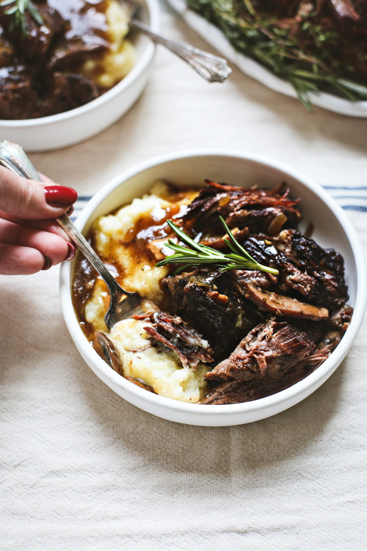 woman eating instant pot chuck roast with mashed potatoes and gravy