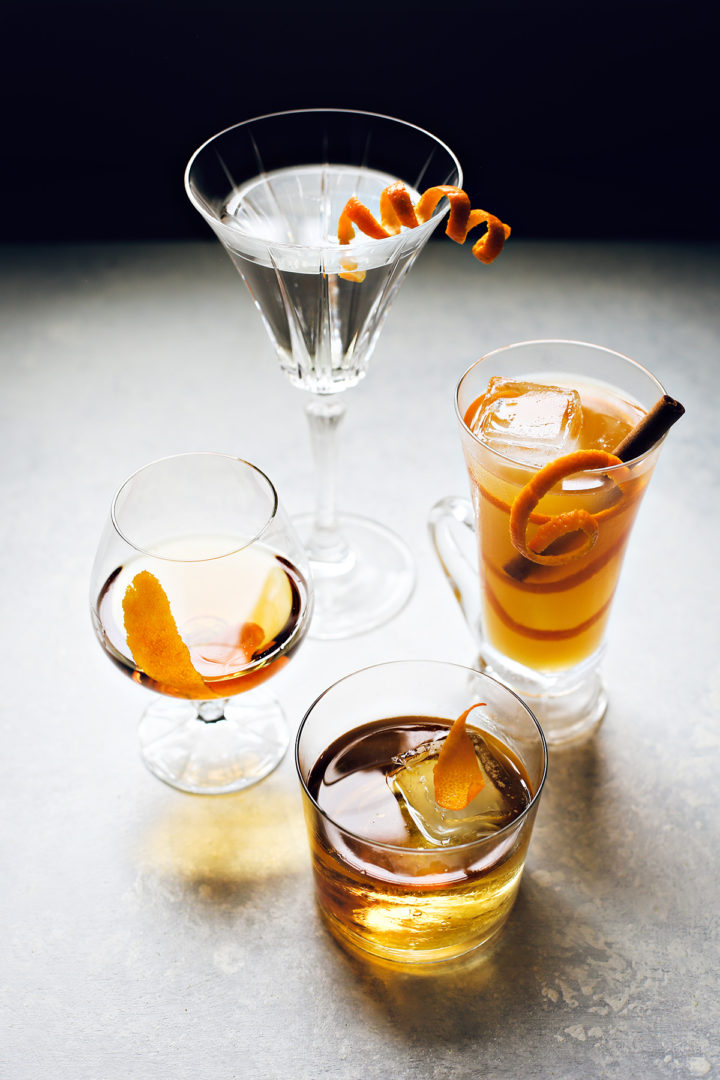 4 cocktails with different types of orange peel garnishes