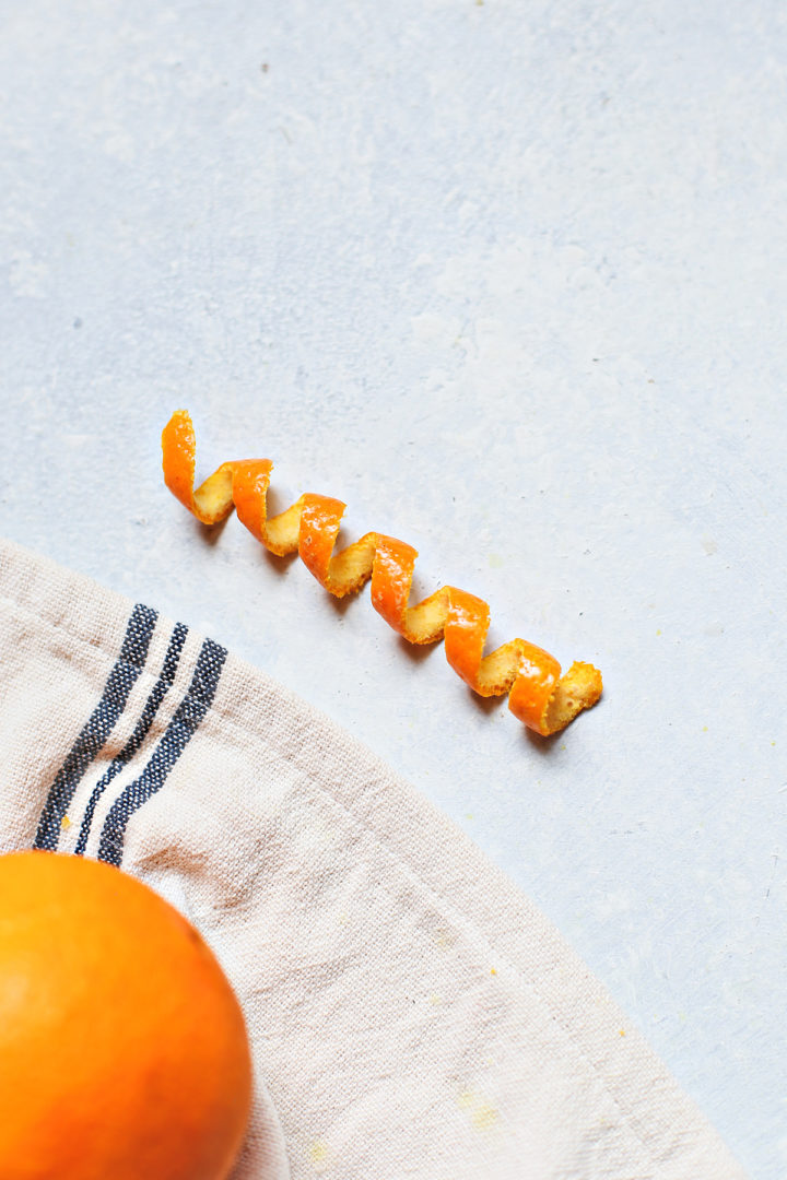 photo of an orange peel corkscrew cocktail garnish