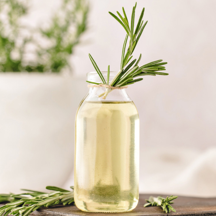 simple syrup with rosemary in a glass bottle