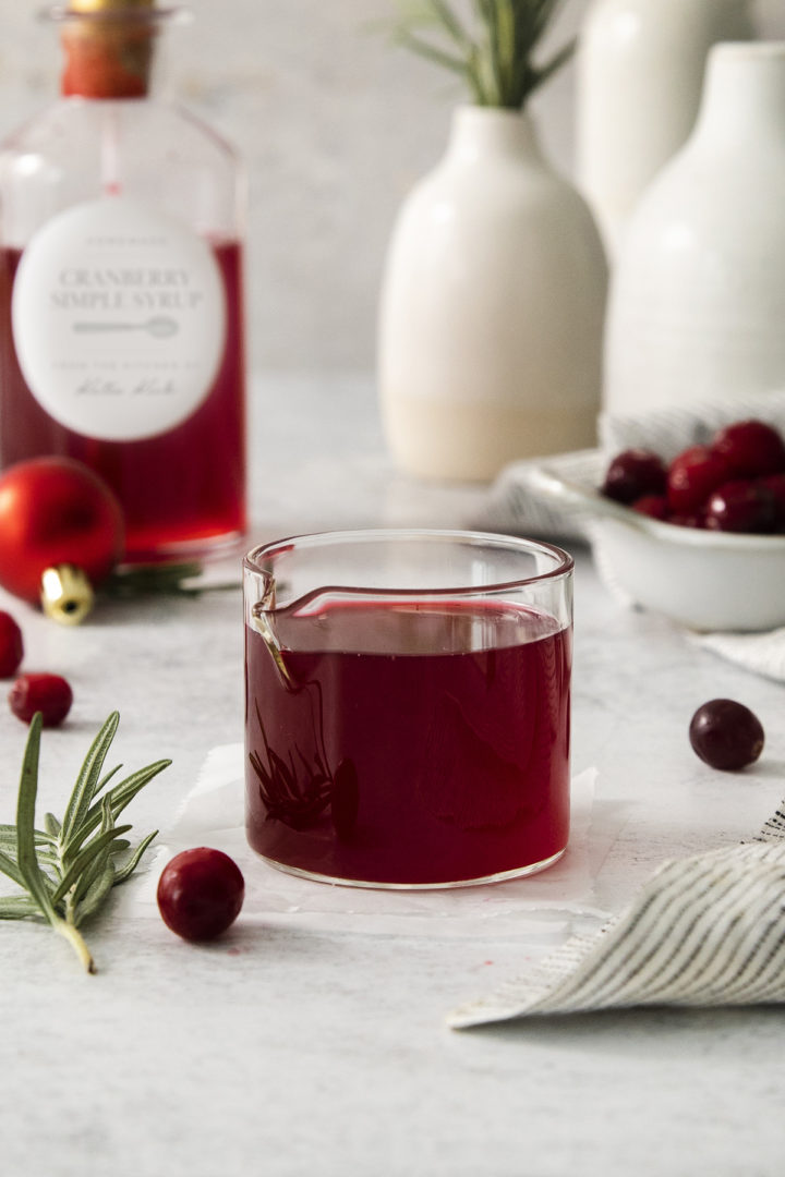 measuring glass of cranberry simple syrup