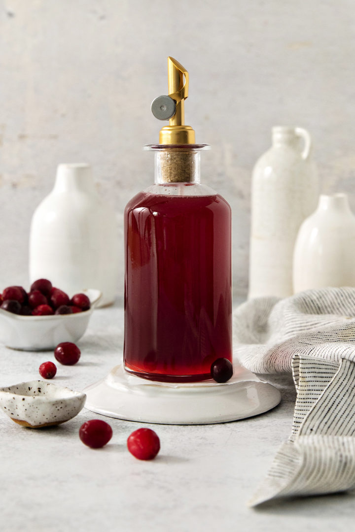 cranberry simple syrup in a glass bottle