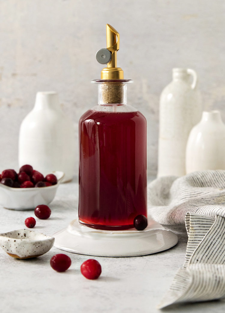 cranberry simple syrup in a glass bottle