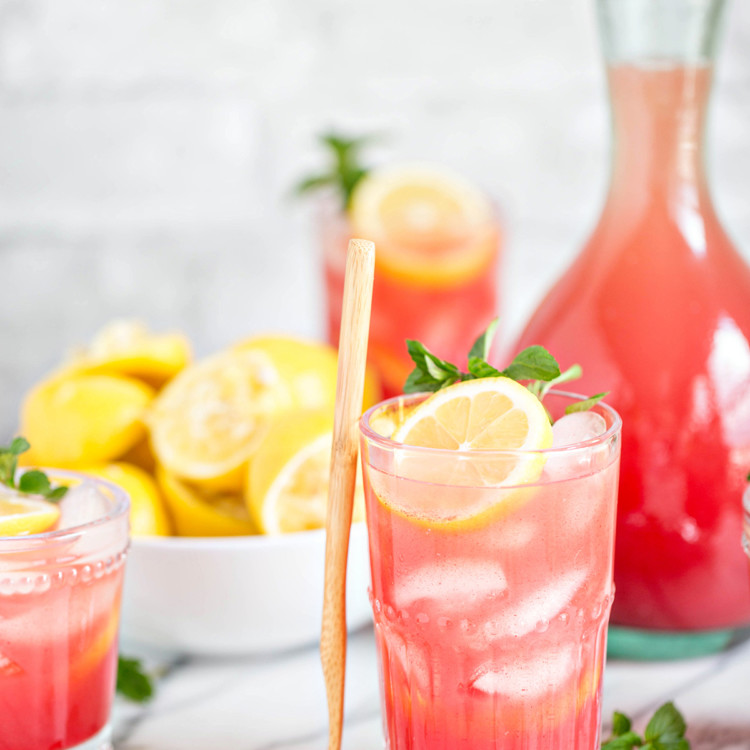 Homemade Watermelon Lemonade in glasses with lemon and mint garnish