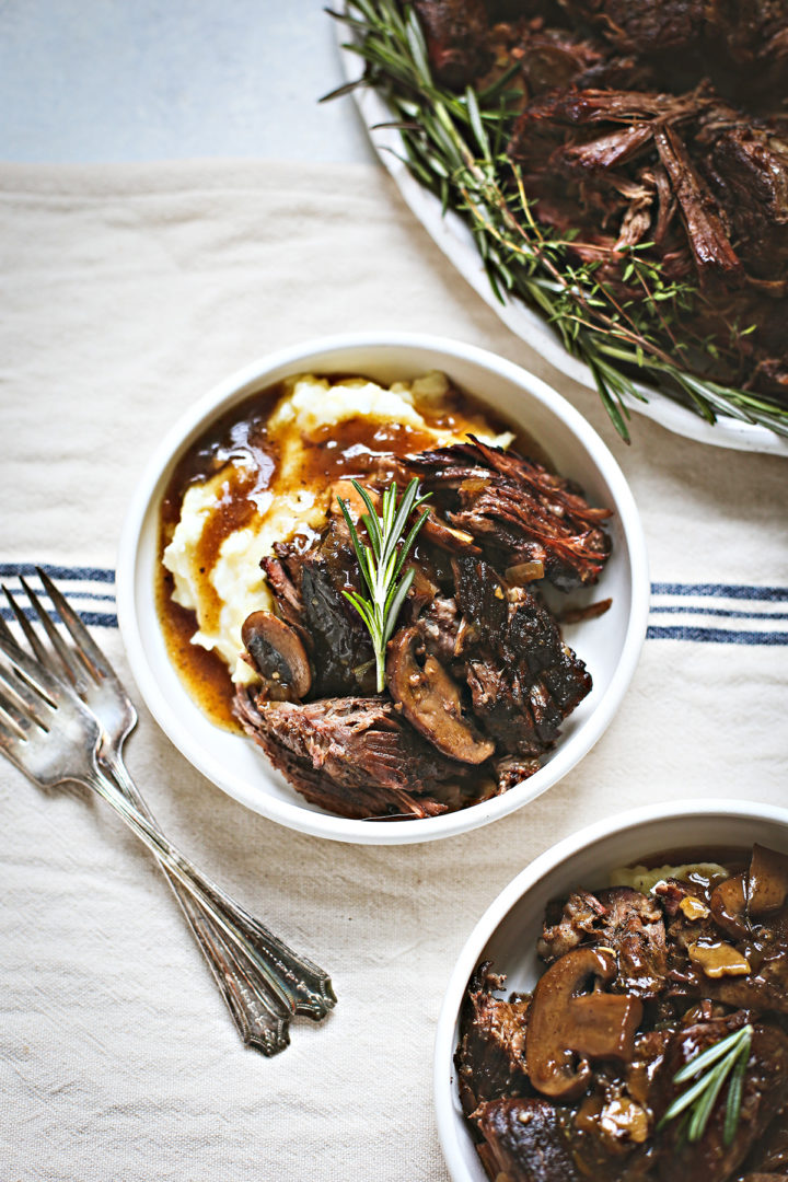 instant pot chuck roast in a bowl with mashed potatoes and mushroom gravy