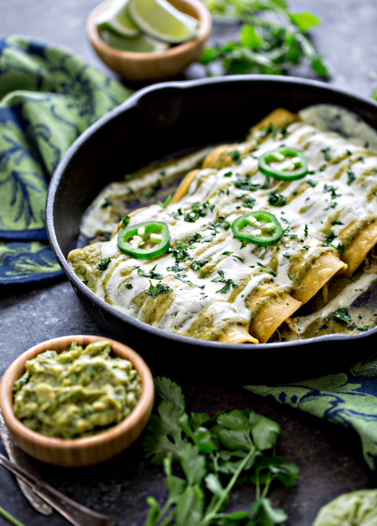 cast iron pan with salsa verde enchiladas