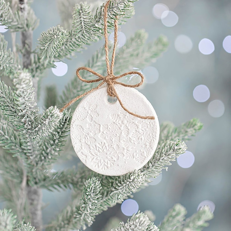 salt dough ornament hanging on a christmas tree branch