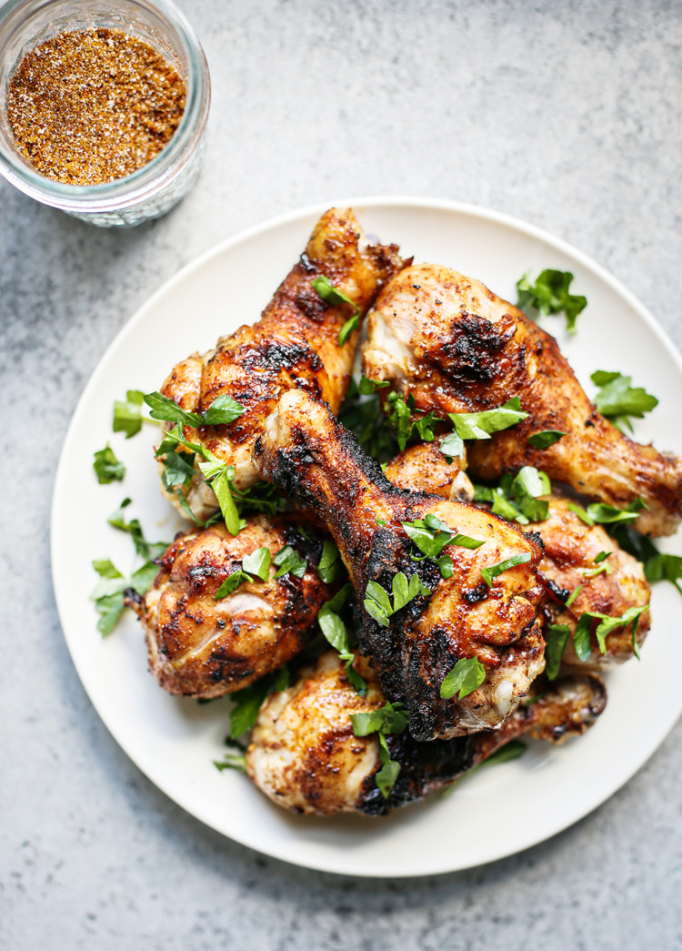 smoked chicken drumsticks on a white plate