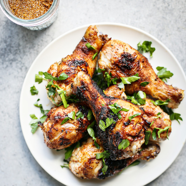 smoked chicken drumsticks on a white plate