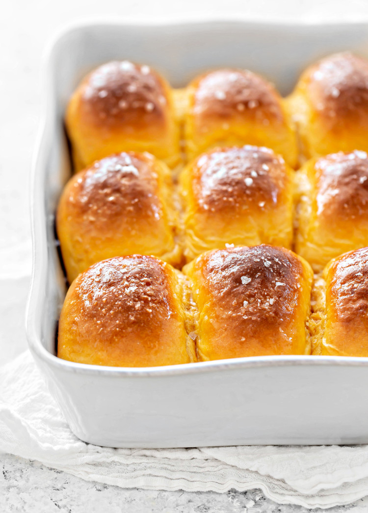 sweet potato rolls in a white baking pan