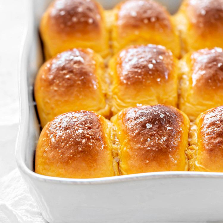 sweet potato rolls in a white baking pan