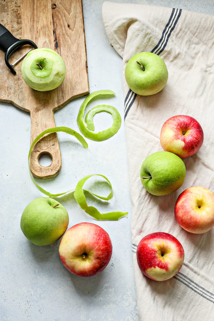 apples being peeled to make apple butter in the instant pot