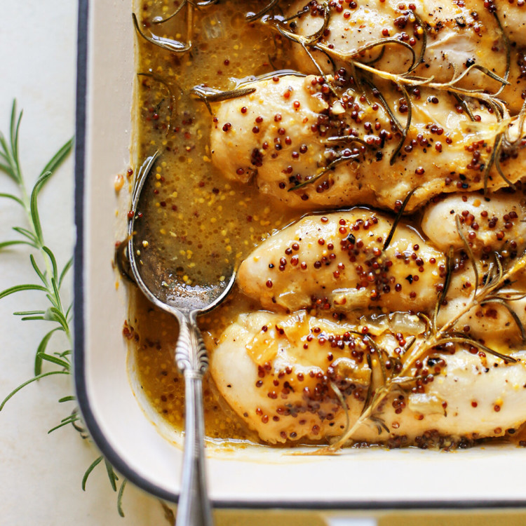 photo of honey mustard chicken in a white baking dish