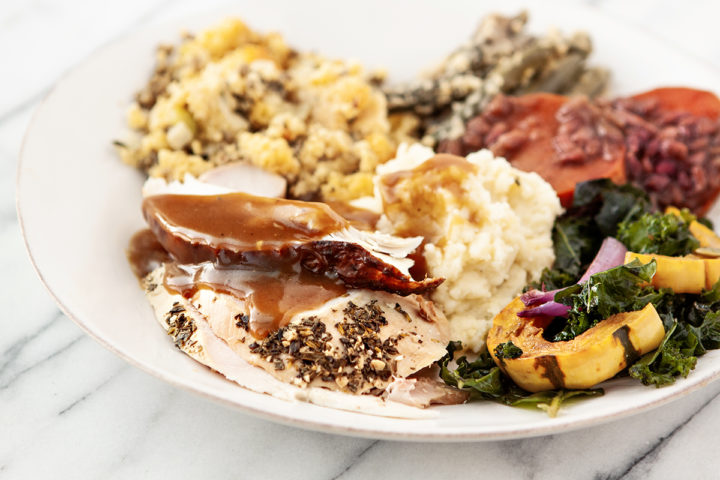 white plate with smoked turkey that was prepared using a turkey brine for smoking