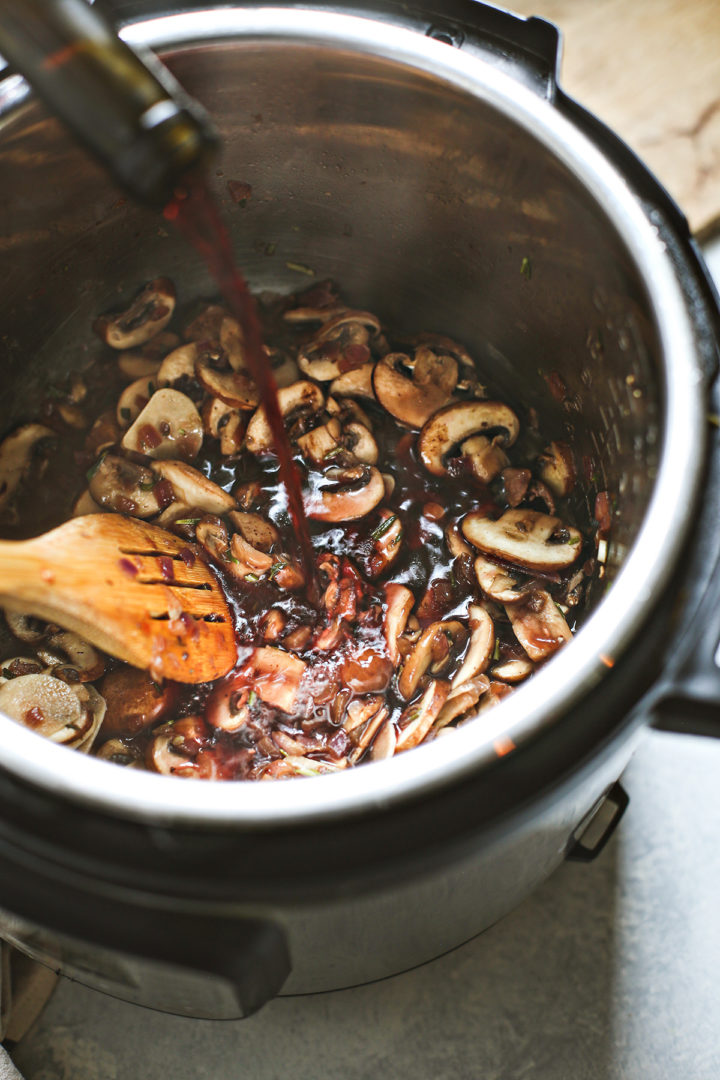 pouring dry red wine for cooking into the instant pot chuck roast recipe