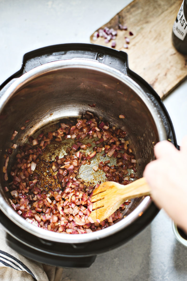 woman showing how to cook onions for an instant pot chuck roast recipe