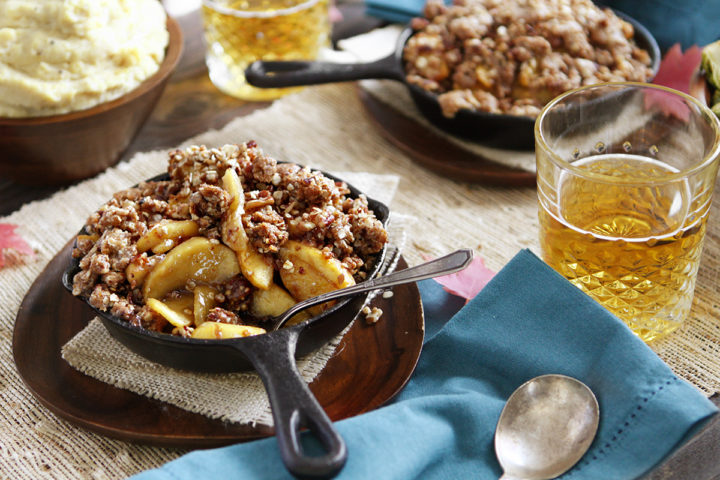 thanksgiving table set with bourbon apple crisp in cast iron pans