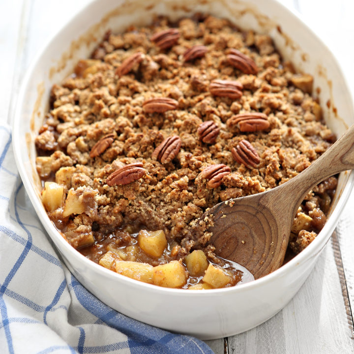 white dish of apple crisp with oatmeal topping